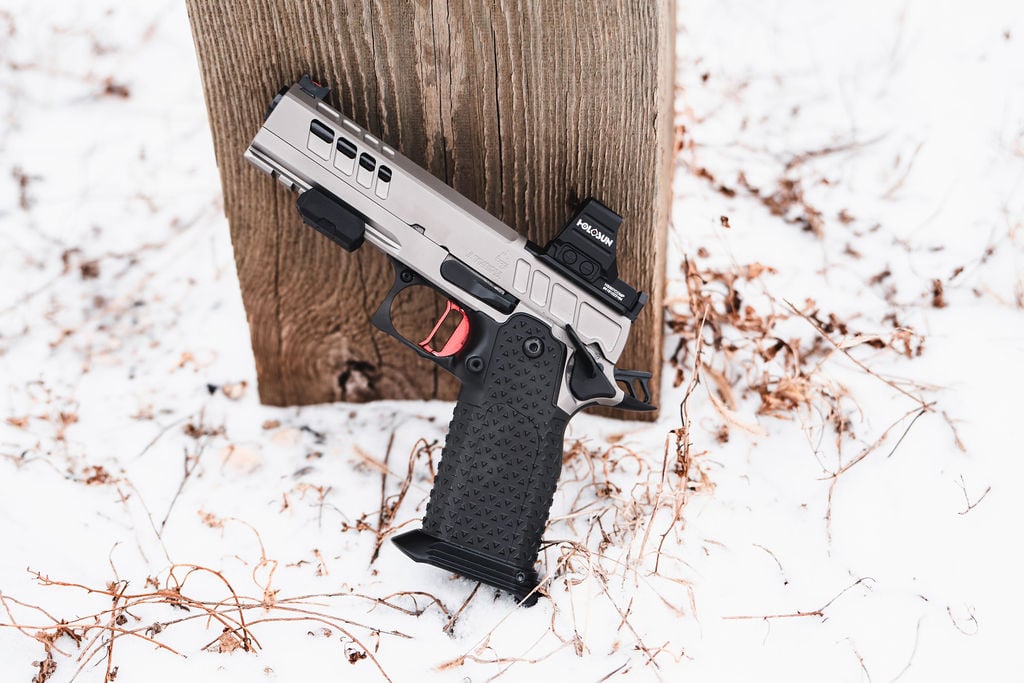 Atlas Gunworks Athena v2 leaning on a post in snow — real product photo, unaltered